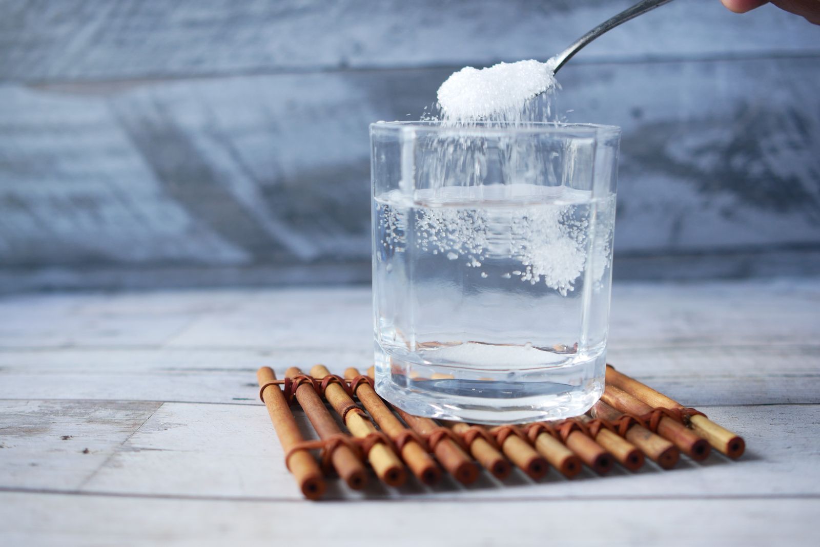 ORS sachet packet being mixed into a glass of water
