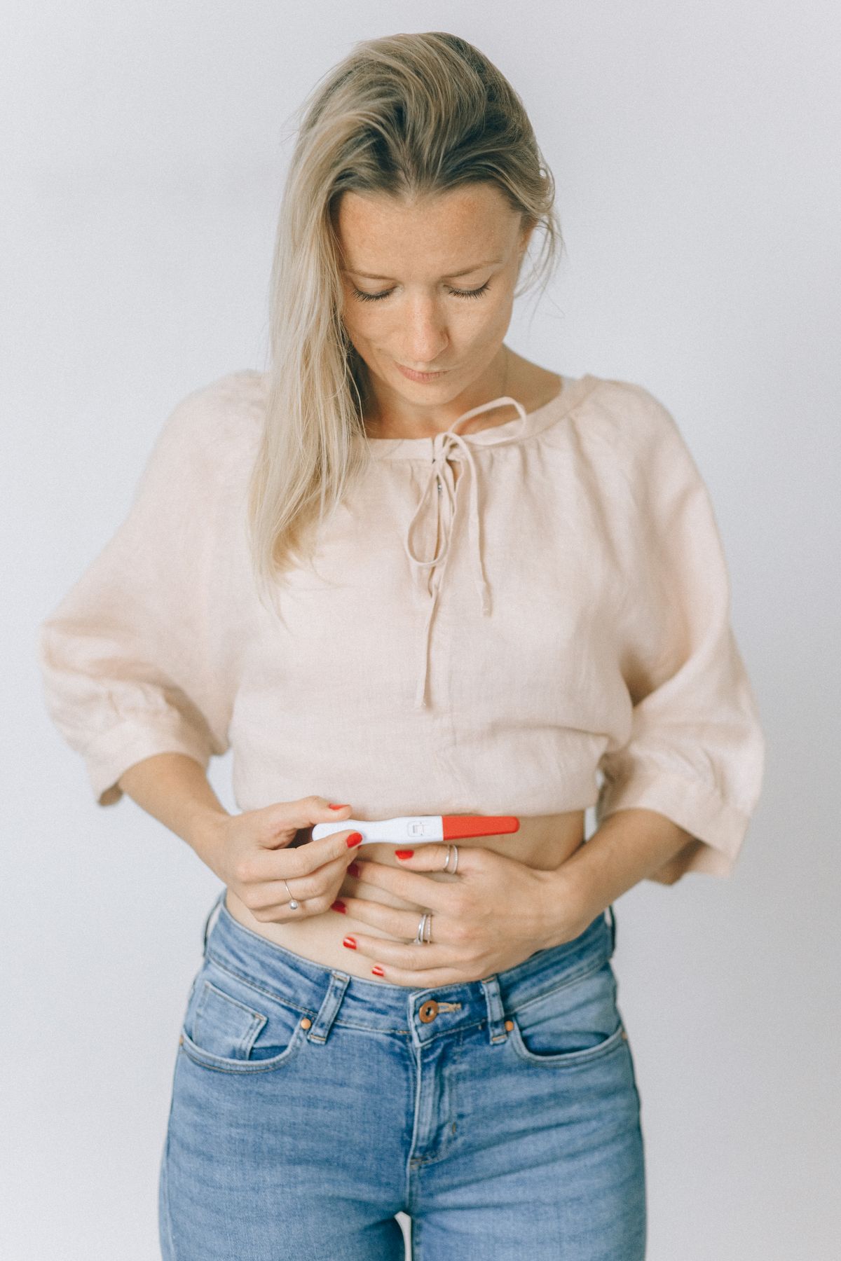 Woman with pregnancy test — early pregnancy