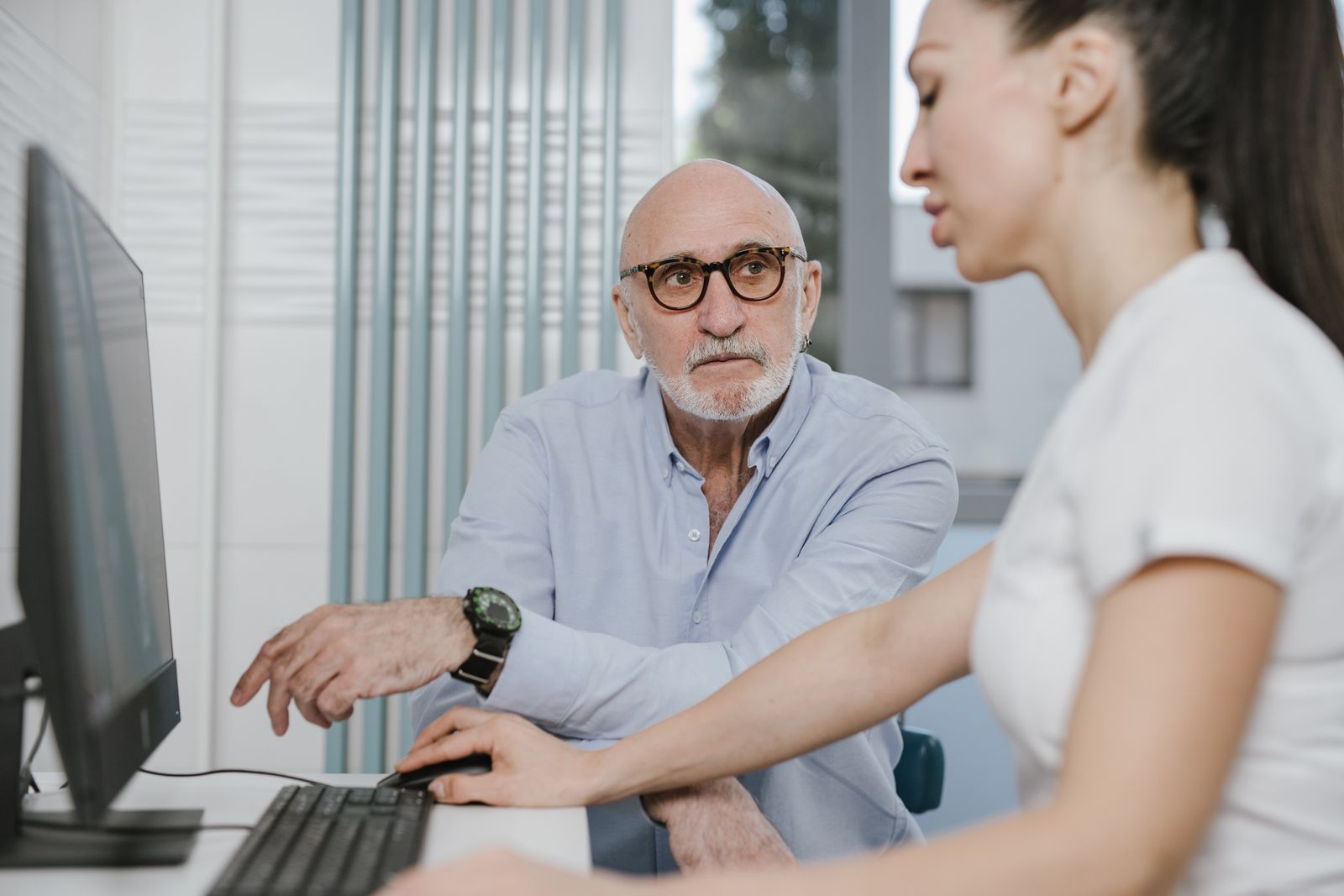 Elderly man consulting doctor about urinary symptoms