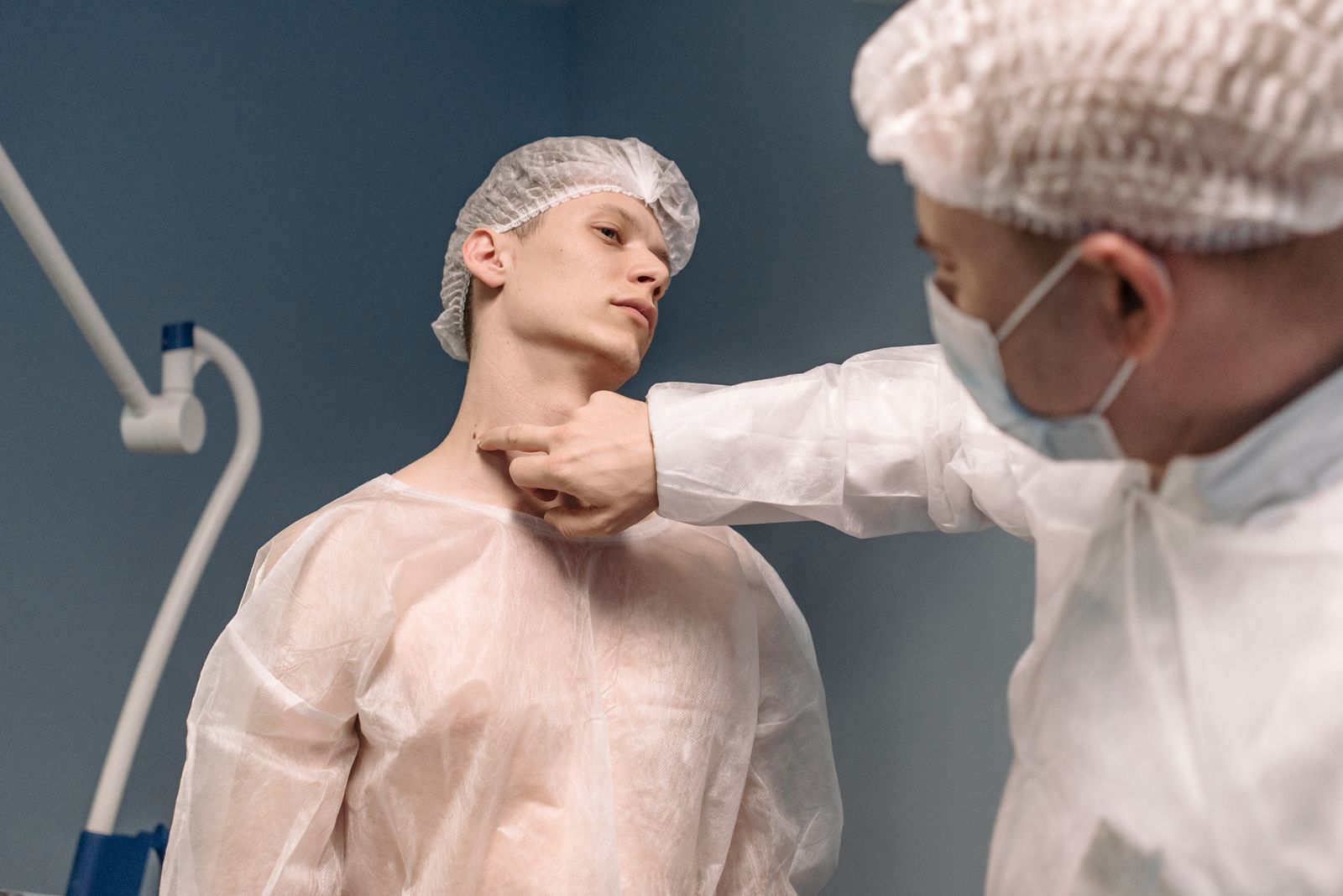Doctor examining a patient's neck and thyroid gland